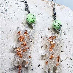 White Playful Cat Dangles with Green Ball